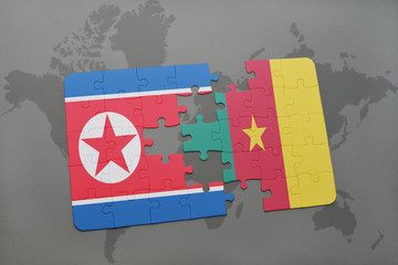 puzzle with the national flag of north korea and cameroon on a world map