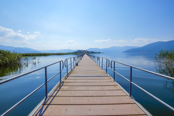 Naklejka premium bridge to island agios achillios small lake prespa greece