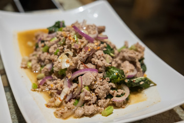 Lab Moo, Chopped pork mix with Thai spicy curry. Served on plate.