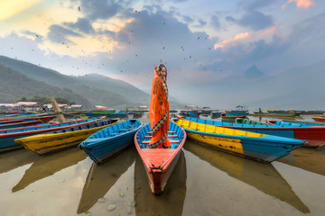 Women in sari standing on the boat,Phewa lake,Pokhara city , Nepal - obrazy, fototapety, plakaty