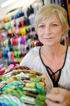 Lady holding embroidery yarns