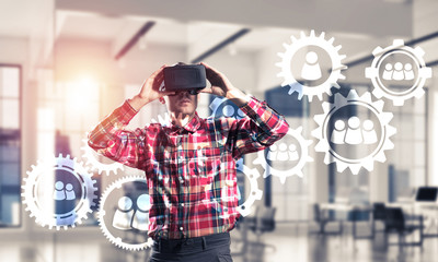 Guy wearing checked shirt and virtual mask demonstrating some em