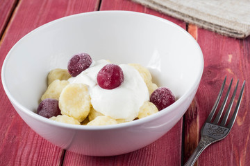 Traditional russian, ukrainian cottage cheese lazy dumplings served with sour cream and cherry