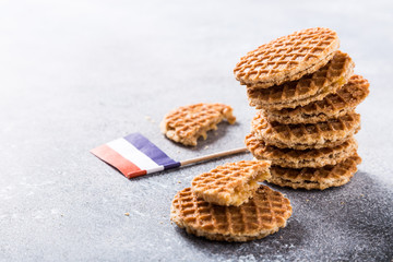 Mini stroopwafel, syrupwaffles cookies and Netherlands national flag light gray background with copy space.