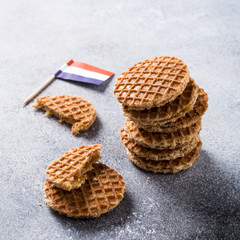 Mini stroopwafel, syrupwaffles cookies and Netherlands national flag light gray background with copy space.