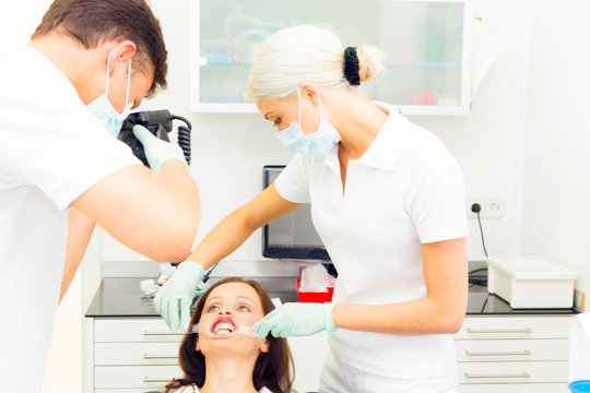 Dentist Taking A Photo Of Patient's Teeth
