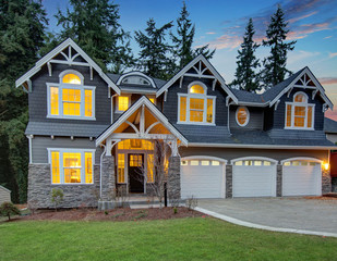 Luxurious blue home with three attached garage spaces