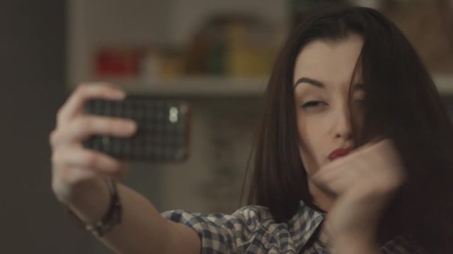 beautiful girl makes selfie at home.