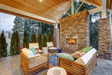 Chic covered back patio with built in gas fireplace