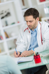 medical physician doctor listening to patient and taking notes