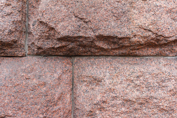 Rustic stone red granite, close-up view, abstract background.