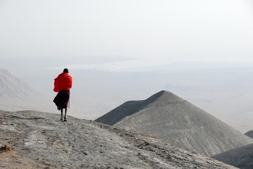 Masai man on hills covered by volcanic ashes, Great Rift Valley, Tanzania, Eastern Africa