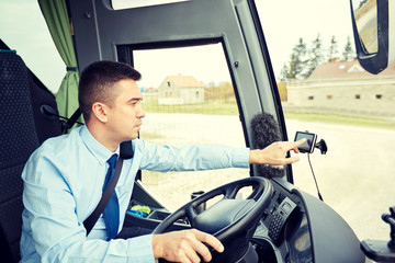 bus driver entering address to gps navigator