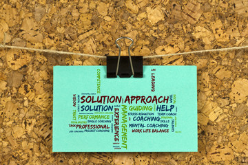 Solution approach word cloud on business card pinned up on cork board