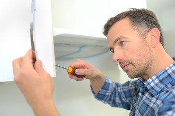 tightening the cupboard's handle