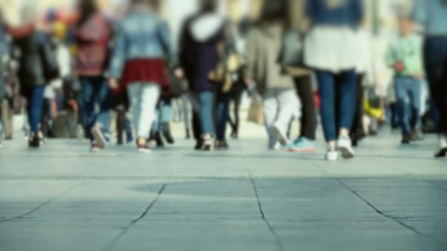 Crowd of pedestrians commute on a busy european city square 100p