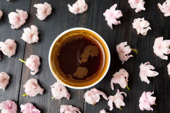Cup of coffee and cherry blossom flowers