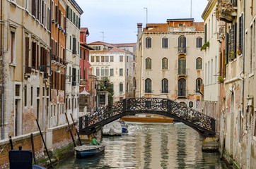 Fototapeta premium one of the many canals, bridge and typical house architecture style of Venice, Italy