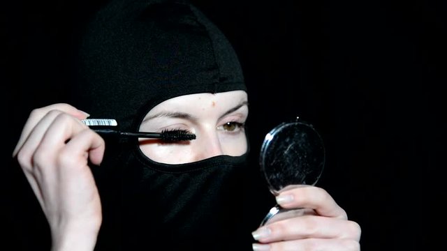 Girl offender. The girl in a black mask.

