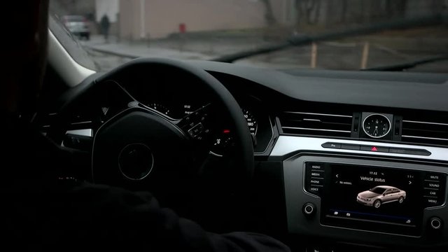 Man drives a car in rainy weather.