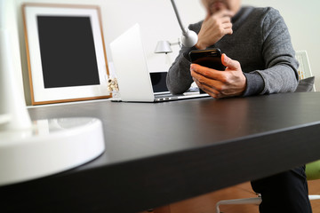 businessman working with smart phone and digital tablet and laptop computer in modern office