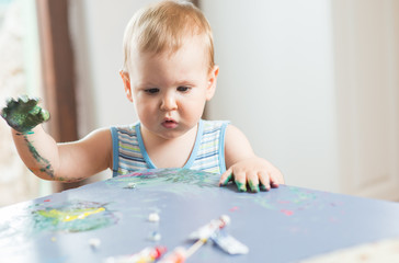 Babies hands painting colorful mosaic