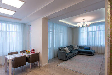 room beige sofa and chandelier