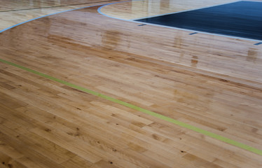 Lines green and blue with newly refinished wood gym floors