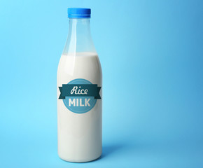Bottle of tasty milk on blue background