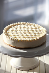 Delicious plain cheesecake on wooden table