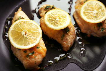Delicious chicken breasts with lemon, closeup