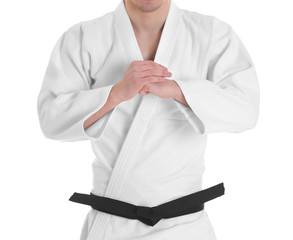 Young sporty man in kimono on white background