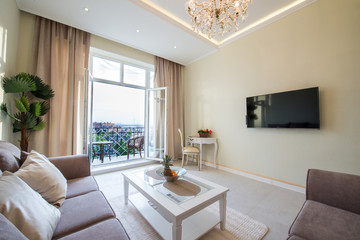Luxury living room interior with classic decorative chandelier and open terrace