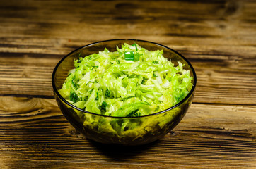 Salad with savoy cabbage and green onion in a bowl