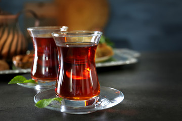 Turkish tea in traditional glasses on table closeup