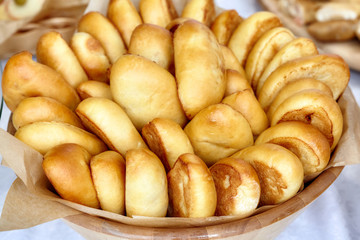 Bowl of oven fresh baked patties, russian pirozhki