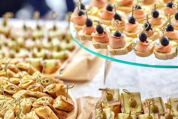 Catering of canape with olives, lemon and salmon