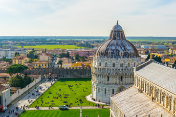 Aerial view of a baptistery and a cathedral in the italian city Pisa.