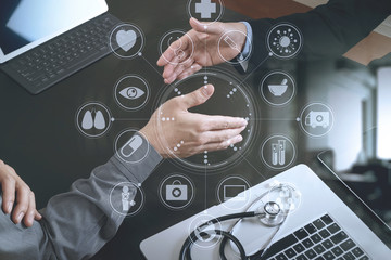 Medical and healthcare concept,Doctor and patient shaking hands in modern office at hospital with virtual computer interface graphic and icons diagram