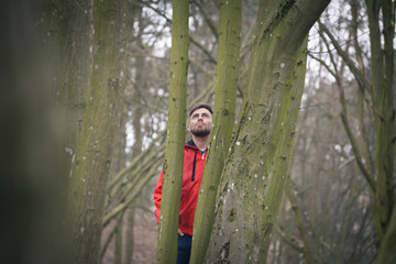 Trendy handsome man posing in spring park alone