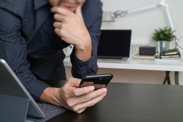 businessman,designer hand using smart phone,laptop, online banking payment communication network technology 4.0,internet wireless application development sync app,modern office