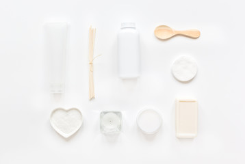 white cosmetic set on desk background top view