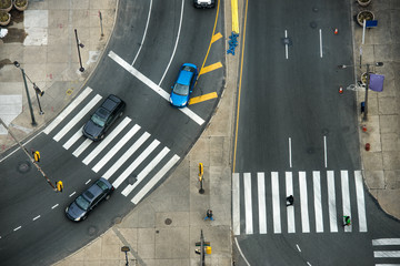 City street with crosswalks on asphalt road and car traffic. Fast city life transportation concept.
