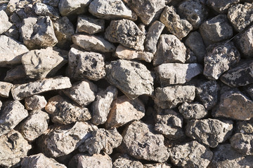 Stone wall with very sharp shadows.