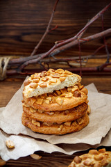 Cookies with a peanut on paper for pastries on wooden table. Selective focus, closeup.