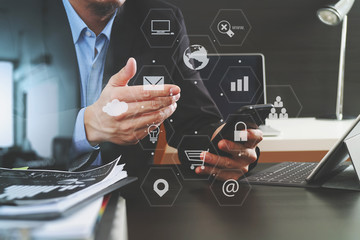 businessman working with smart phone and digital tablet and laptop computer in modern office