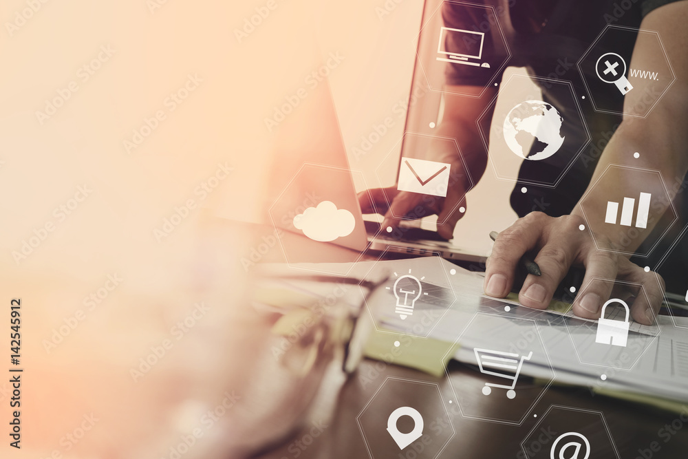 Poster businessman working with laptop computer and document on wooden desk in modern office with virtual icons interface