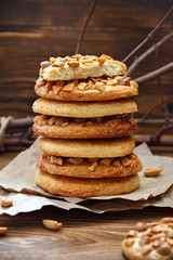 Cookies with a peanut on paper for pastries on wooden table. Selective focus, closeup.