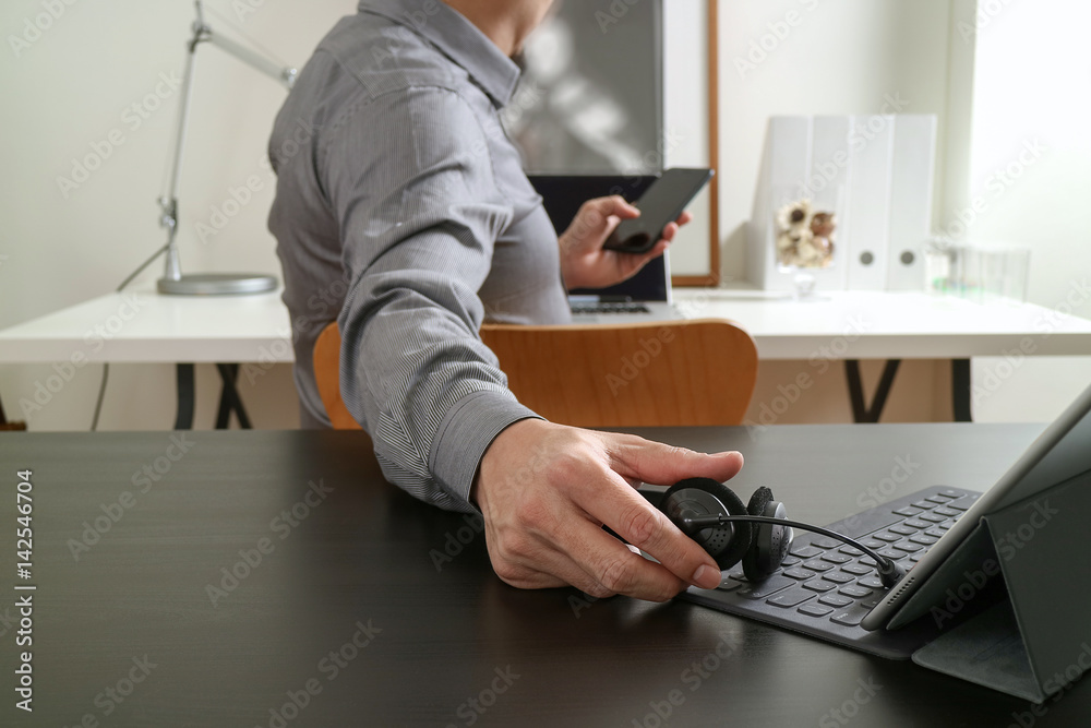 Aufkleber businessman using voip headset with digital tablet computer and smart phone,as concept communication