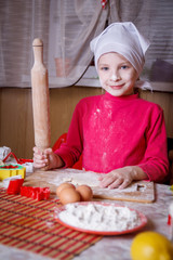 Girl making dough with rolling pin